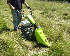 Image of Sickle bar mower mowing along a fence